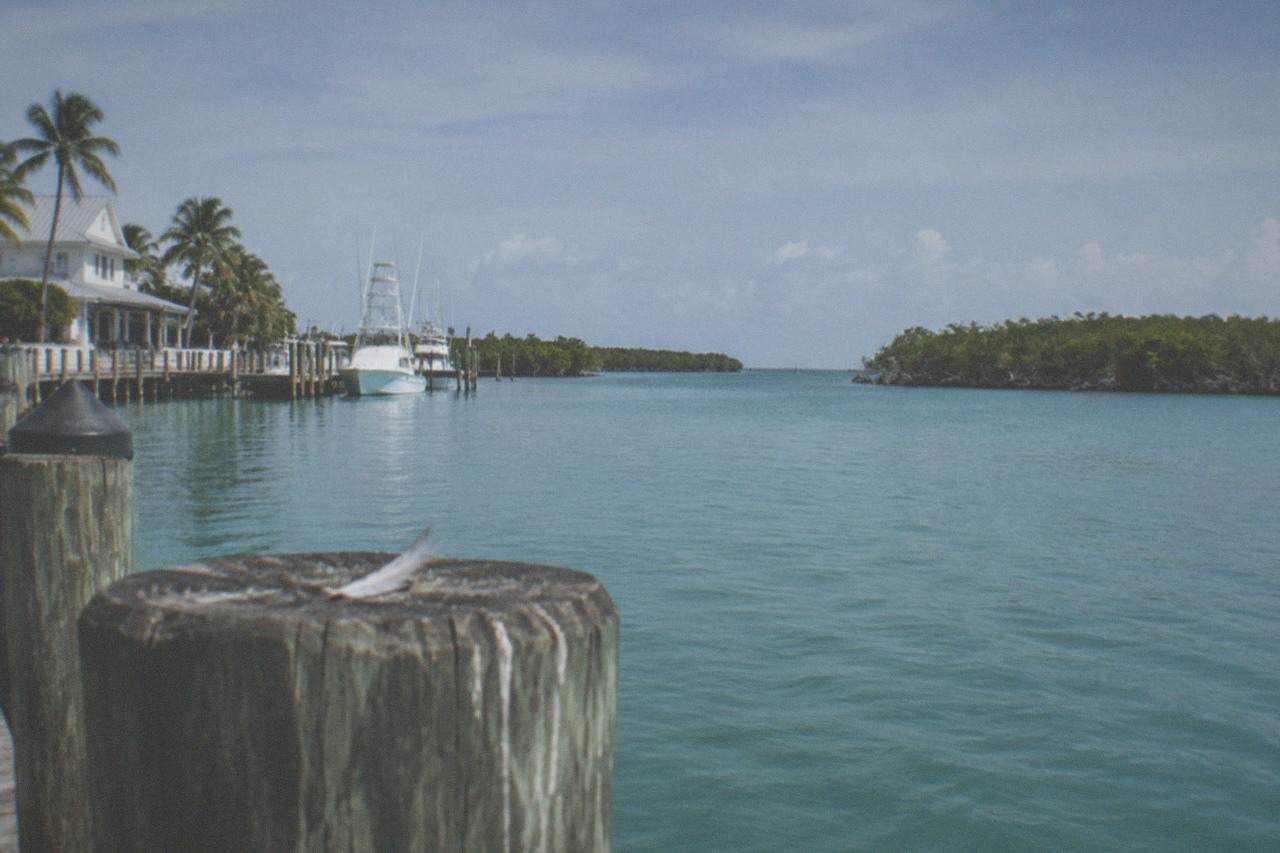 Calm turquoise flats water stretching toward mangrove islands under a wide sky