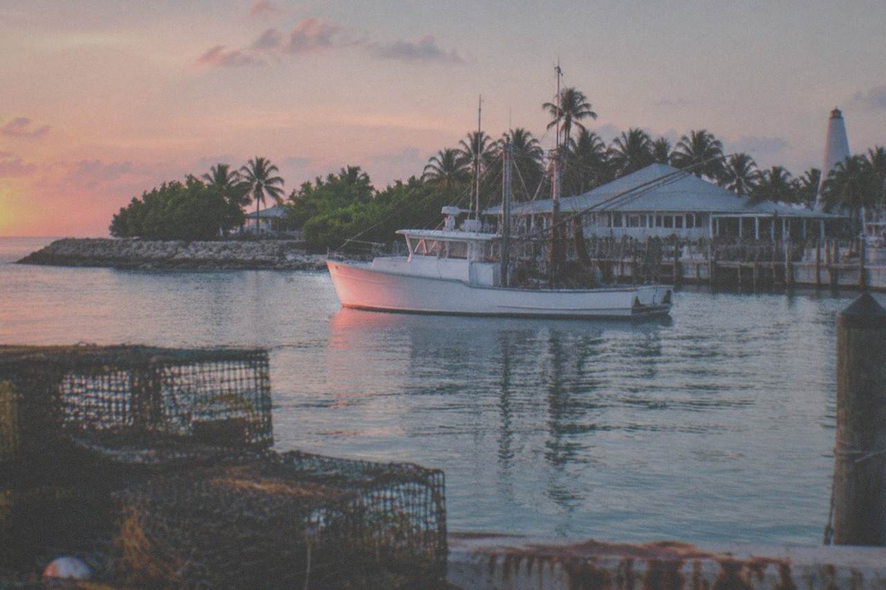 Fishing boat on calm turquoise water near Key West at sunrise