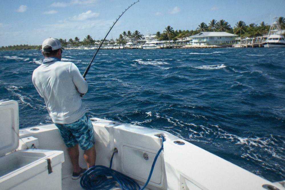 Sportfishing boat running offshore over deep blue open water