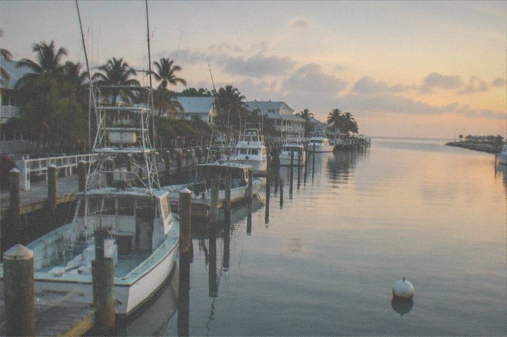 Calm morning water at a Key West marina with fishing boats at the dock