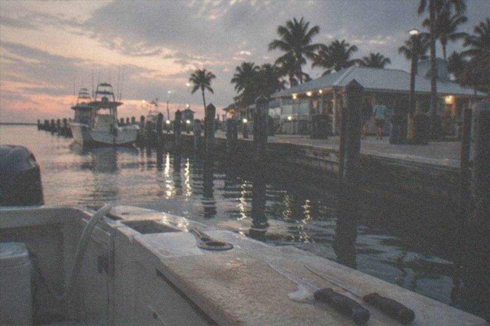 Close view of a charter boat transom with fillet knives and a cutting board after a day of fishing